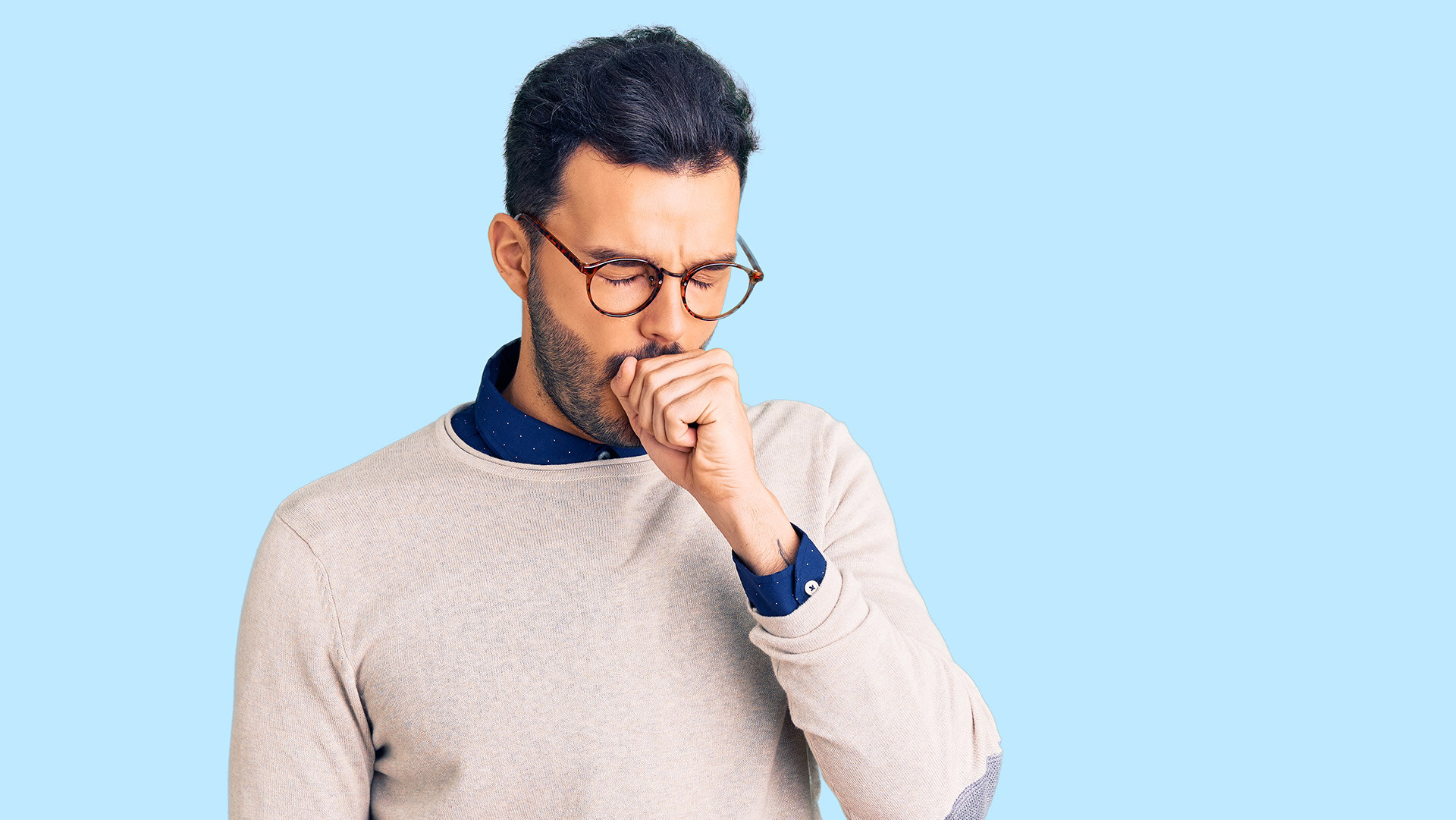 A man coughing, highlighting potential issues of vaping-related cough or sore throat.